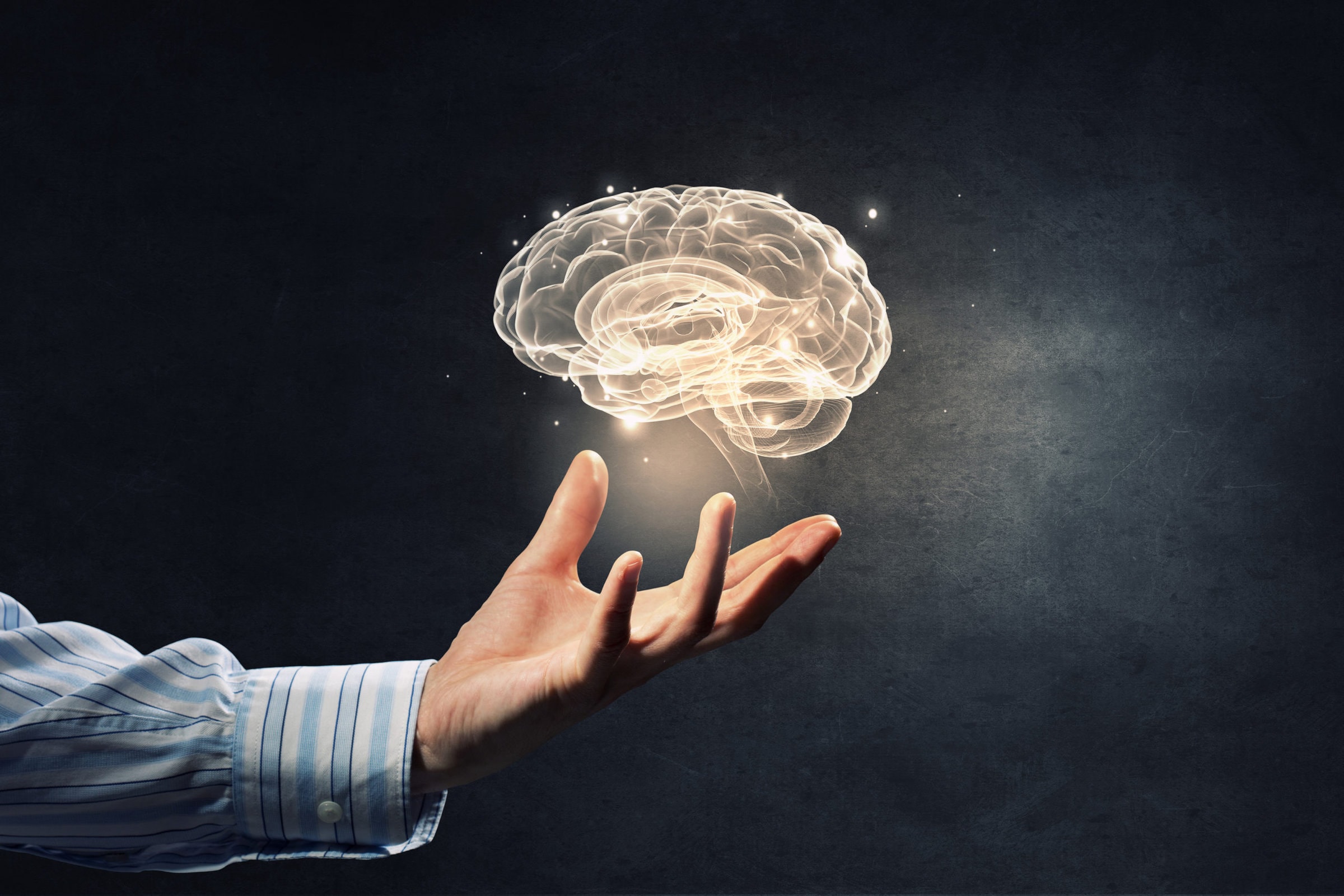 Mental health concept Close up of human hand holding brain symbiol