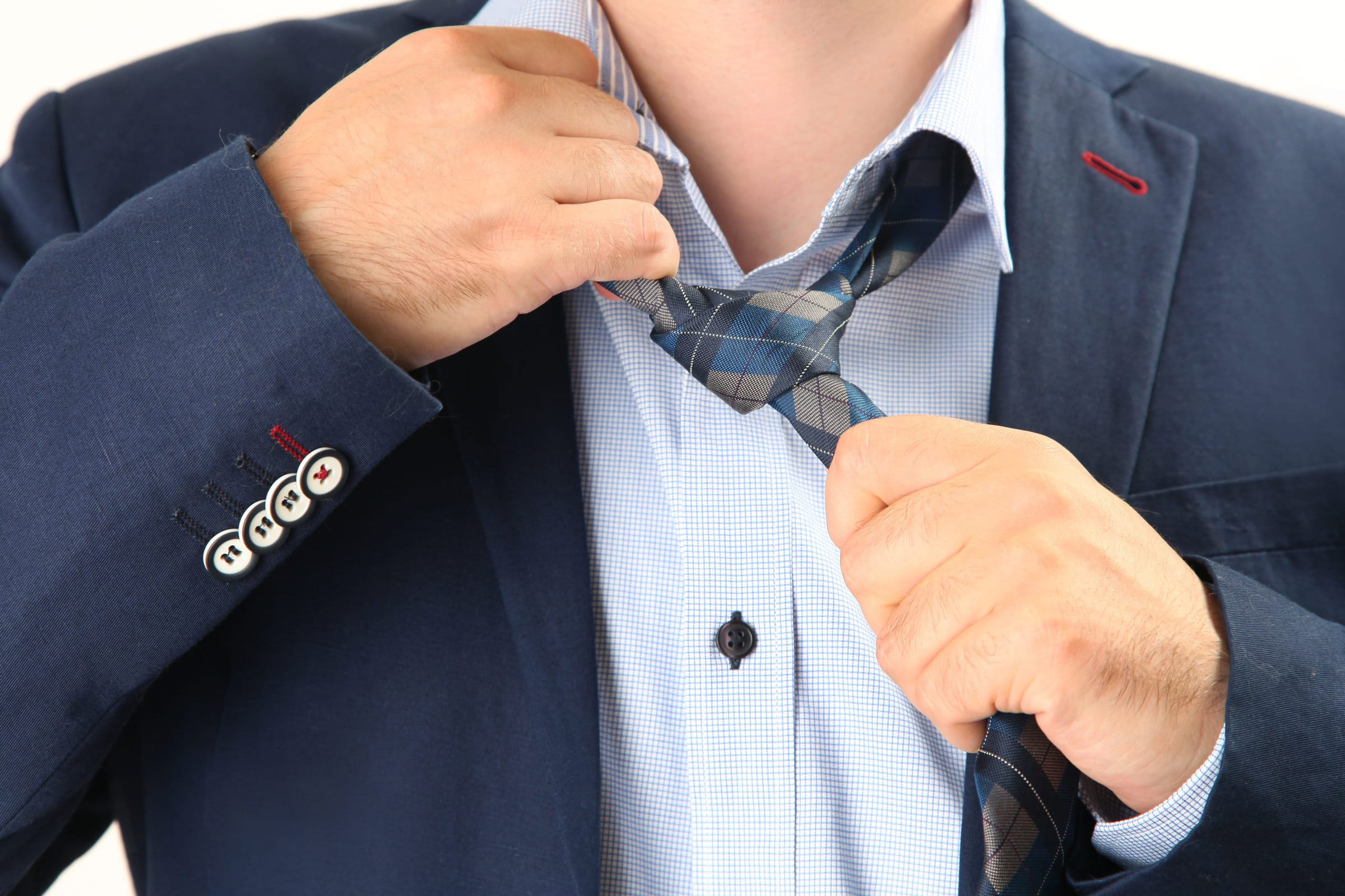 tired businessman taking off necktie