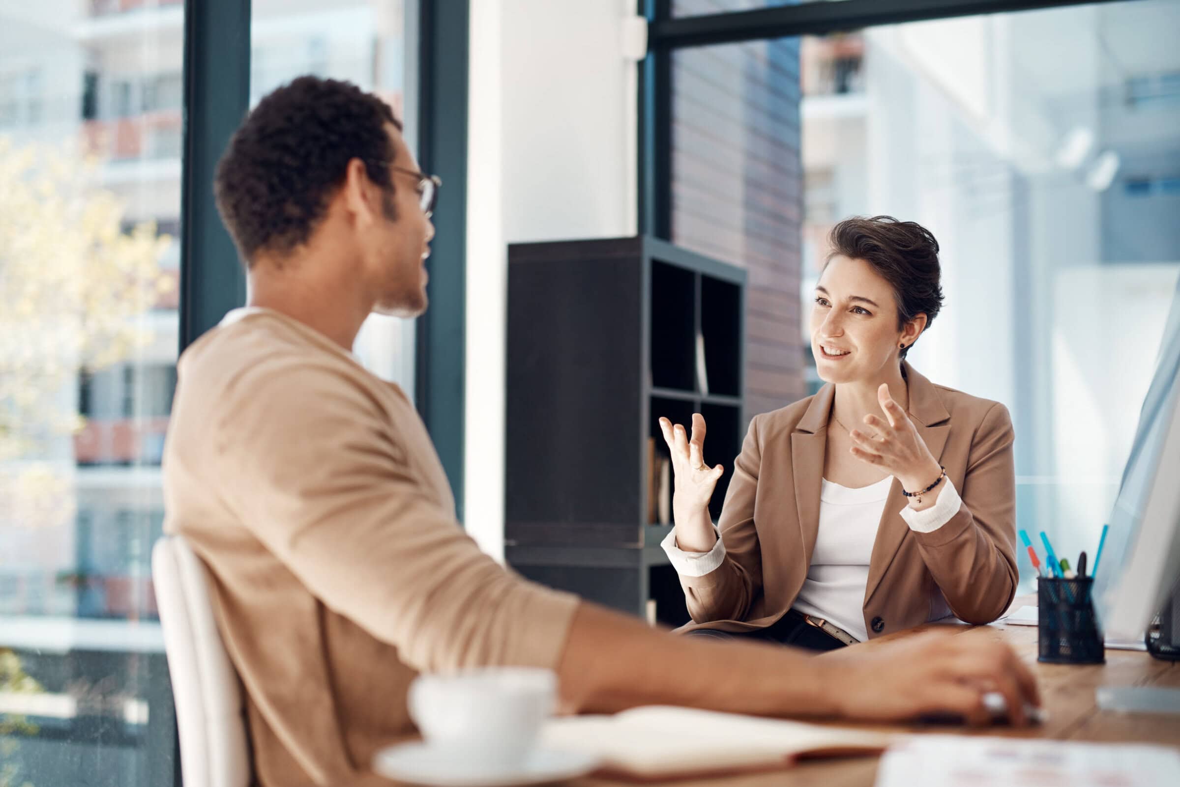Mentor, training and a woman manager with an employee in the office for coaching on company vision. Management, meeting and a female business person talking to a professional male colleague at work Mentor, training and a woman manager with an employee in the office for coaching on company vision. Management, meeting and a female business person talking to a professional male colleague at work.