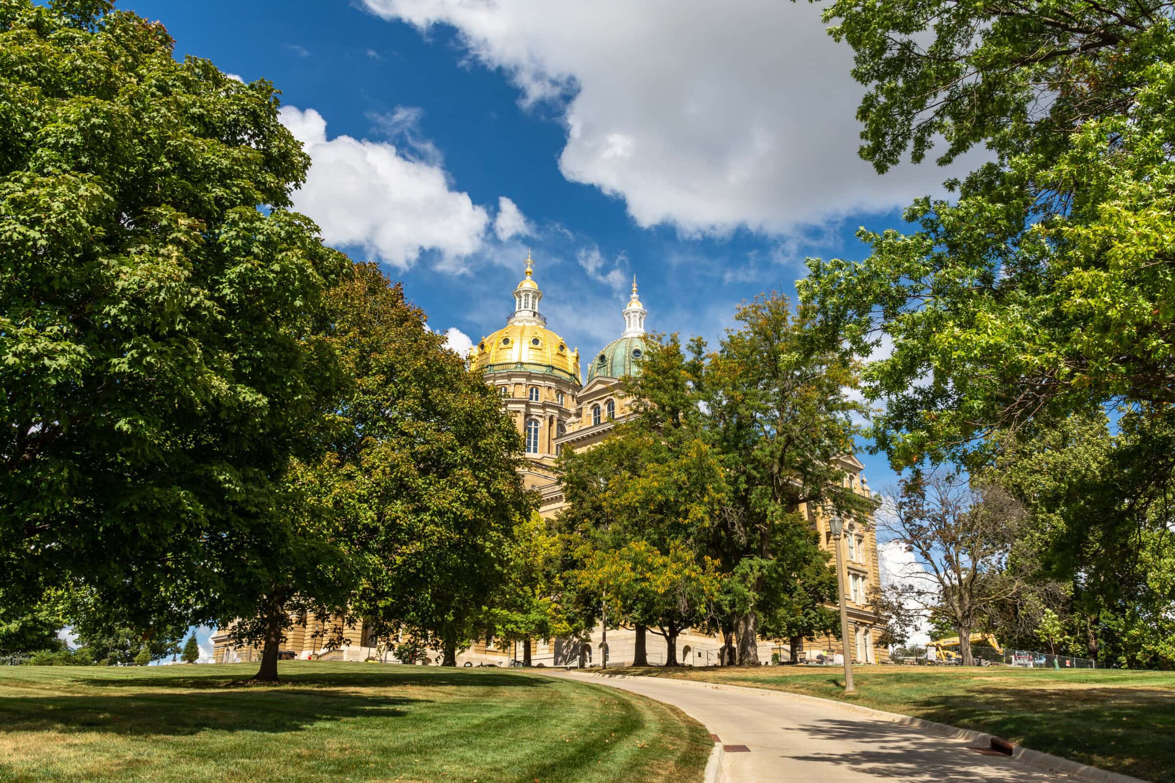 The Iowa state Capitol building on a hot late summer day with blue skies and clouds. Des Moines, Iowa, USA. The Iowa state Capitol building on a hot late summer day with blue skies and clouds. Des Moines, Iowa, USA.