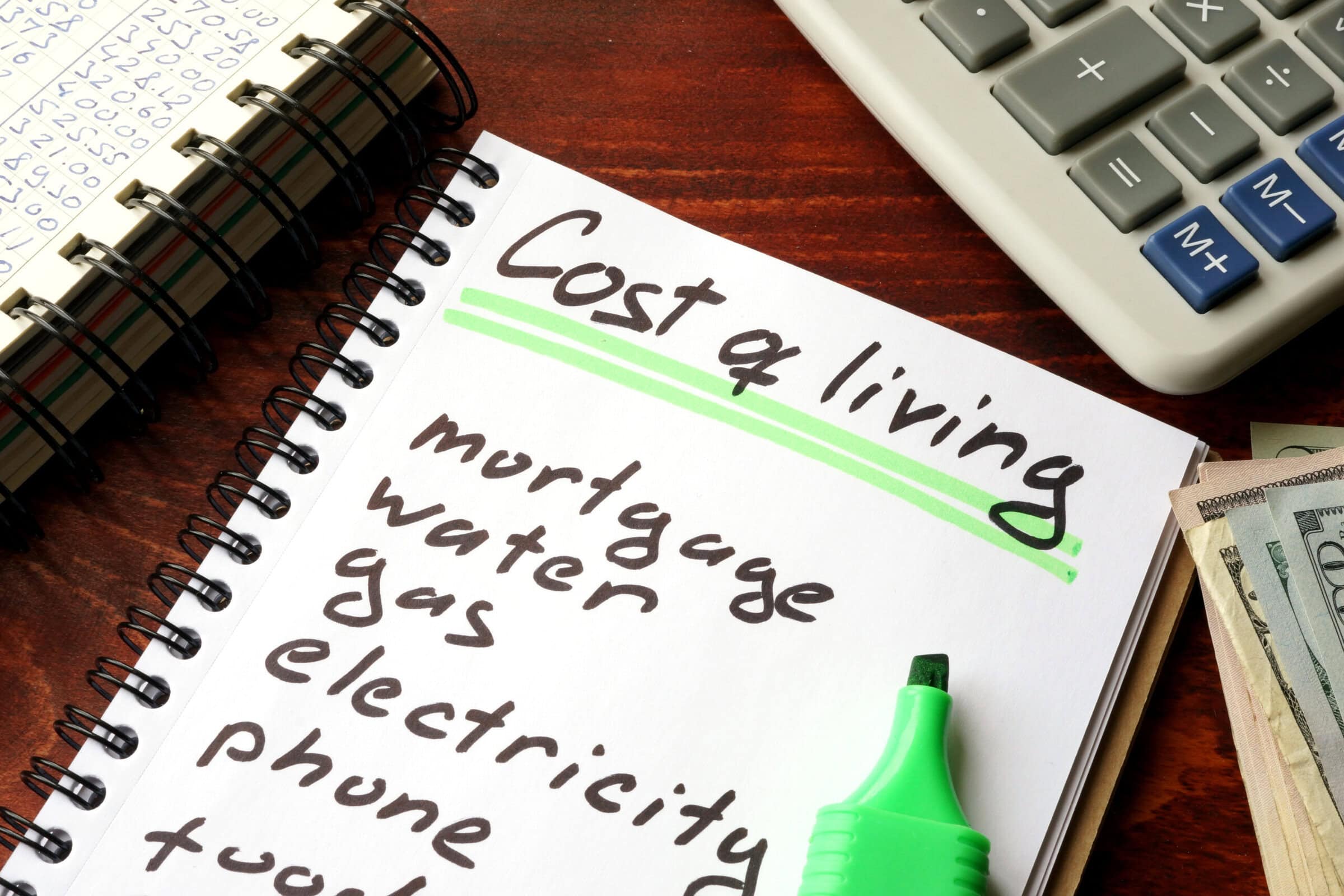 Cost of living written in a notebook and calculations of home finances. Cost of living written in a notebook and calculations of home finances.