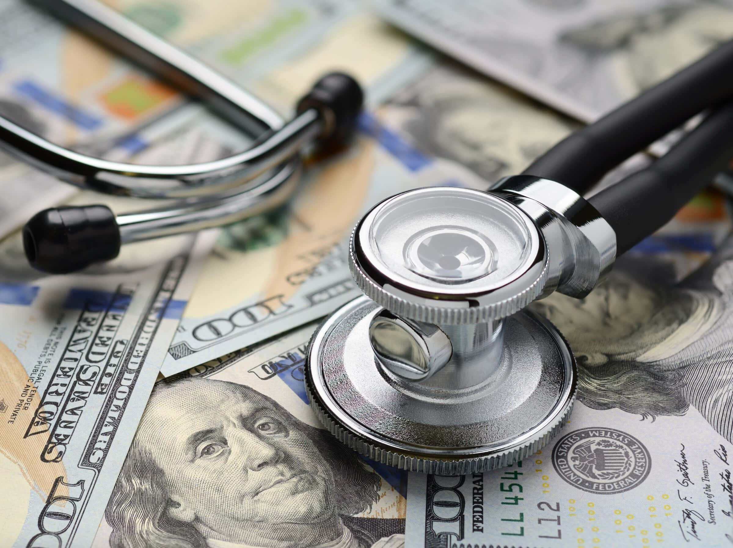 Medical stethoscope and dollar bills Medical stethoscope and dollar bills