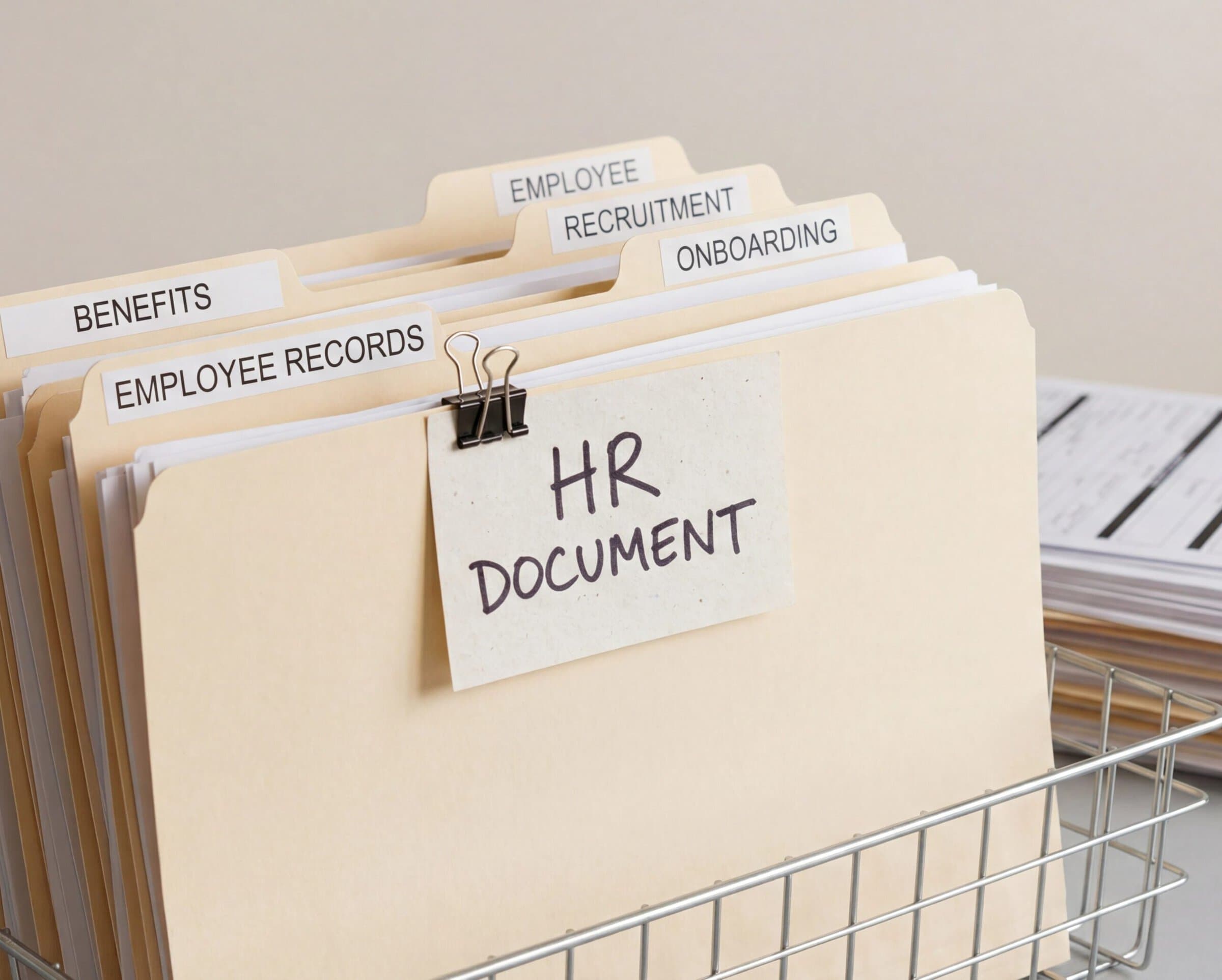 personnel records HR document management system with labeled file folders for employee records benefits recruitment and onboarding in wire desk organizer for human resources administration and compliance