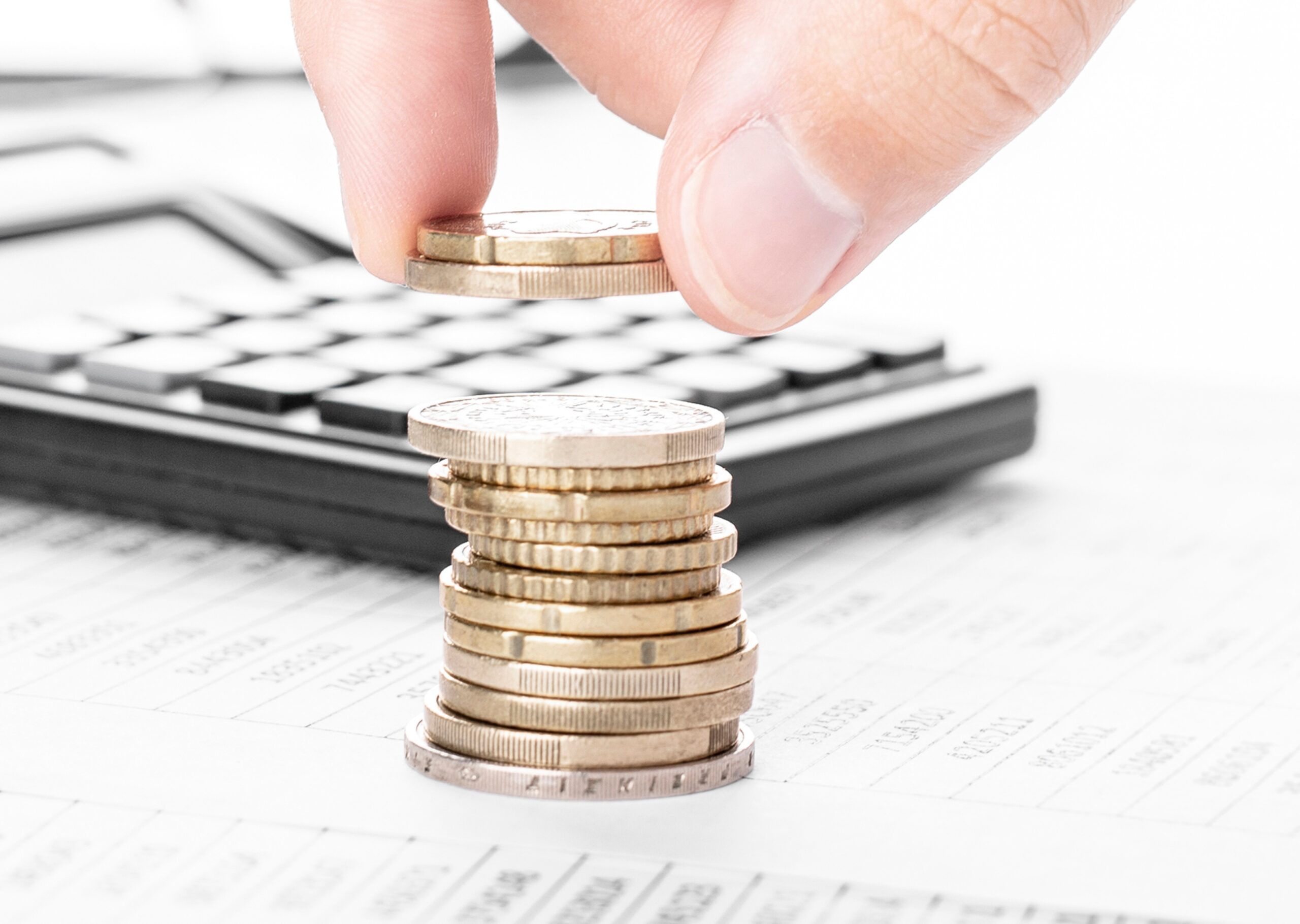 Businessman counting money and making stack of coins on financia Businessman counting money and making stack of coins on financia